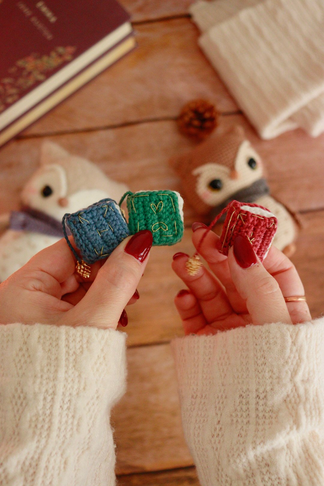 Trois mini grimoires au crochet rouge, vert et bleu avec broderies dorées et perles pomme de pin – accessoires du kit hibou